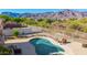 Aerial view of a beautiful pool with desert landscaping and mountain views at 4297 S Pony Rider Trl, Gold Canyon, AZ 85118