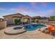 Backyard pool and spa with a covered patio and desert landscaping; ideal for outdoor living and entertaining at 4297 S Pony Rider Trl, Gold Canyon, AZ 85118