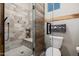 Modern shower with bench seating, pebble floor, and glass door at 4297 S Pony Rider Trl, Gold Canyon, AZ 85118