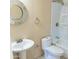 Bathroom with a toilet, sink, round mirror, and a shower/bathtub at 4625 W Thomas Rd # 50, Phoenix, AZ 85031