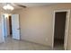 Bedroom featuring tile floors and neutral paint leading to the closet and bathroom at 4625 W Thomas Rd # 50, Phoenix, AZ 85031