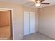 Bright bedroom featuring a ceiling fan and double-door closet at 4625 W Thomas Rd # 50, Phoenix, AZ 85031
