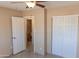 Bedroom with a closet and view into the bathroom, featuring tile floors and neutral paint at 4625 W Thomas Rd # 50, Phoenix, AZ 85031