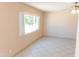 Cozy bedroom featuring tile flooring and a window that brightens the space at 4625 W Thomas Rd # 50, Phoenix, AZ 85031