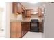 Classic kitchen featuring wood cabinets, tile backsplash, and modern appliances at 4625 W Thomas Rd # 50, Phoenix, AZ 85031