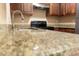 A chef's haven featuring granite countertops, stainless steel appliances, and modern dark wood cabinetry at 4625 W Thomas Rd # 50, Phoenix, AZ 85031