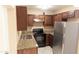 Well-lit kitchen boasting granite counters, stainless steel appliances, and sleek dark wood cabinetry at 4625 W Thomas Rd # 50, Phoenix, AZ 85031