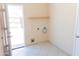 Utility room with tile flooring, shelving, and connections for laundry appliances at 4625 W Thomas Rd # 50, Phoenix, AZ 85031