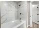 Bathroom features marble-style tiled walls and a deep white bathtub at 5303 N 7Th St # 326, Phoenix, AZ 85014
