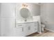 Bathroom vanity with white cabinets, white countertops, and a round mirror over the sink at 5303 N 7Th St # 326, Phoenix, AZ 85014