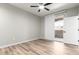 Bright bedroom with wood-look floors features a sliding glass door leading to a balcony at 5303 N 7Th St # 326, Phoenix, AZ 85014