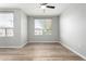 Bedroom features neutral walls, wood floors, ceiling fan and a window for natural light at 5303 N 7Th St # 326, Phoenix, AZ 85014