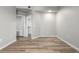 A simple bedroom with hardwood floors, white walls, and view of the walk-in closet at 5303 N 7Th St # 326, Phoenix, AZ 85014