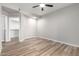 A simple bedroom featuring a ceiling fan, wood-look floors, and a walk in closet at 5303 N 7Th St # 326, Phoenix, AZ 85014