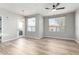 Bright living room boasts wood floors, two large windows, and a stylish chandelier at 5303 N 7Th St # 326, Phoenix, AZ 85014