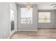 Open concept living space featuring modern light fixture, windows, and glass door at 5303 N 7Th St # 326, Phoenix, AZ 85014