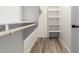 A simple walk-in closet with shelves and wood-look floors at 5303 N 7Th St # 326, Phoenix, AZ 85014