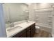 Bright bathroom featuring a double sink vanity with dark brown cabinets and a shower and tub combo at 5669 S 253Rd Ave, Buckeye, AZ 85326