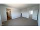Spacious bedroom with neutral carpet and a view of the hallway and a doorway to an adjoining room at 5669 S 253Rd Ave, Buckeye, AZ 85326