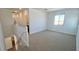 Upstairs loft area with natural light, neutral carpet, and a view of the exterior at 5669 S 253Rd Ave, Buckeye, AZ 85326