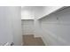 Empty walk-in closet with basic metal shelving and neutral carpet at 5669 S 253Rd Ave, Buckeye, AZ 85326