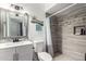 Bathroom with tiled shower, updated vanity, and tiled floors at 617 E Calle Adobe Ln, Goodyear, AZ 85338