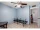 Bedroom with blue walls, tile flooring and ceiling fan at 617 E Calle Adobe Ln, Goodyear, AZ 85338
