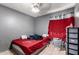 Red bedroom features neutral walls and a ceiling fan at 617 E Calle Adobe Ln, Goodyear, AZ 85338