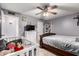 Bedroom features tile floors, ceiling fan, and a white dresser and crib at 617 E Calle Adobe Ln, Goodyear, AZ 85338
