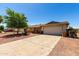 This charming single-story home offers an inviting driveway leading to a well-maintained property at 617 E Calle Adobe Ln, Goodyear, AZ 85338