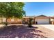 Charming single-story home featuring a low maintenance yard and a two-car garage at 617 E Calle Adobe Ln, Goodyear, AZ 85338