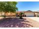Charming single-story home featuring a low maintenance yard and a two-car garage at 617 E Calle Adobe Ln, Goodyear, AZ 85338