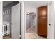 Hallway with wood cabinet and view to baby room at 617 E Calle Adobe Ln, Goodyear, AZ 85338
