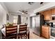 View of kitchen and dining area with stainless steel refrigerator and wooden table at 617 E Calle Adobe Ln, Goodyear, AZ 85338