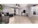 Spacious living room featuring tile floors, a ceiling fan, and a comfortable sofa at 617 E Calle Adobe Ln, Goodyear, AZ 85338