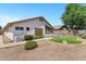 Expansive backyard featuring desert landscaping, including a small lawn and a screened in patio off the house at 625 W Douglas Ave, Gilbert, AZ 85233