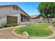 A spacious backyard featuring a well-maintained lawn, desert landscaping, and a sunroom with ample natural light at 625 W Douglas Ave, Gilbert, AZ 85233