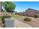 View of the backyard with desert landscaping, a small lawn and tall brick walls for privacy at 625 W Douglas Ave, Gilbert, AZ 85233