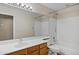 Bathroom with wood vanity, sink, toilet and tub/shower combo at 625 W Douglas Ave, Gilbert, AZ 85233