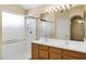 Bathroom with double sink vanity, white shower and large mirror at 625 W Douglas Ave, Gilbert, AZ 85233