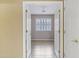 Bedroom view through doorway reveals tile floors and plantation shutters on the window at 625 W Douglas Ave, Gilbert, AZ 85233