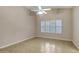 Bright bedroom features tile flooring, large window with shutters, and ceiling fan at 625 W Douglas Ave, Gilbert, AZ 85233