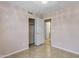 Bedroom features tile flooring, closet and open doorway to hall at 625 W Douglas Ave, Gilbert, AZ 85233