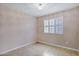 Bedroom features a window with plantation shutters, tile flooring and neutral walls at 625 W Douglas Ave, Gilbert, AZ 85233