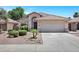 Charming single-story home with a well-manicured front yard, desert landscaping, and a two-car garage at 625 W Douglas Ave, Gilbert, AZ 85233
