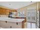 Kitchen with stainless steel appliances, peninsula island and access to backyard via french doors at 625 W Douglas Ave, Gilbert, AZ 85233