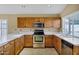 Traditional kitchen features wooden cabinets, stainless steel appliances and white countertops at 625 W Douglas Ave, Gilbert, AZ 85233