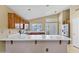 Kitchen with breakfast bar, stainless steel fridge, and double french doors to outdoor space at 625 W Douglas Ave, Gilbert, AZ 85233