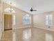 Bright and open living room featuring tile floors, chandelier, and custom window shutters at 625 W Douglas Ave, Gilbert, AZ 85233