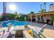 Relaxing backyard with a pool, patio, outdoor seating, and lush landscaping for entertaining at 6255 E Crocus Dr, Scottsdale, AZ 85254